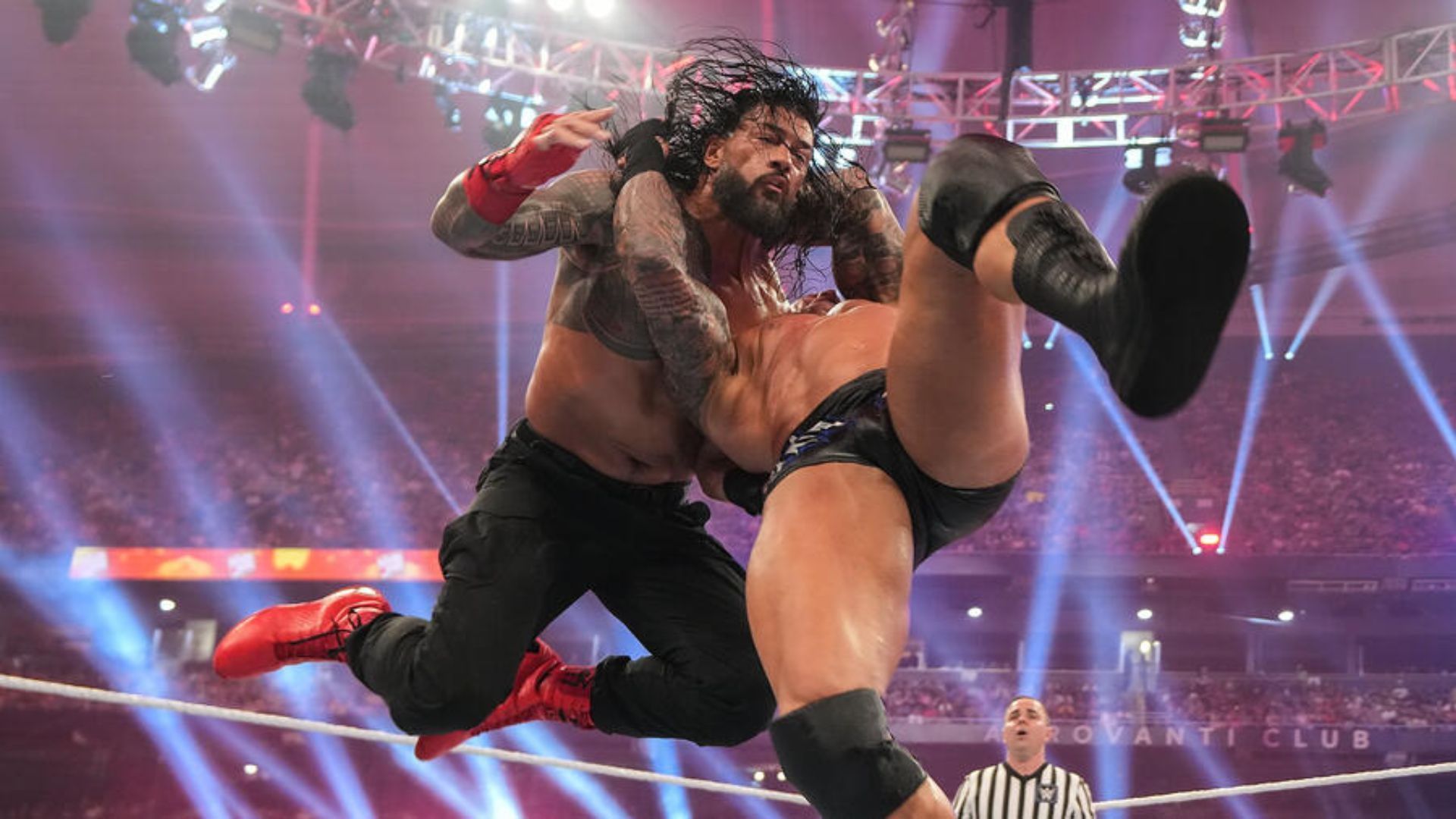 Randy Orton hitting an RKO on Roman Reigns