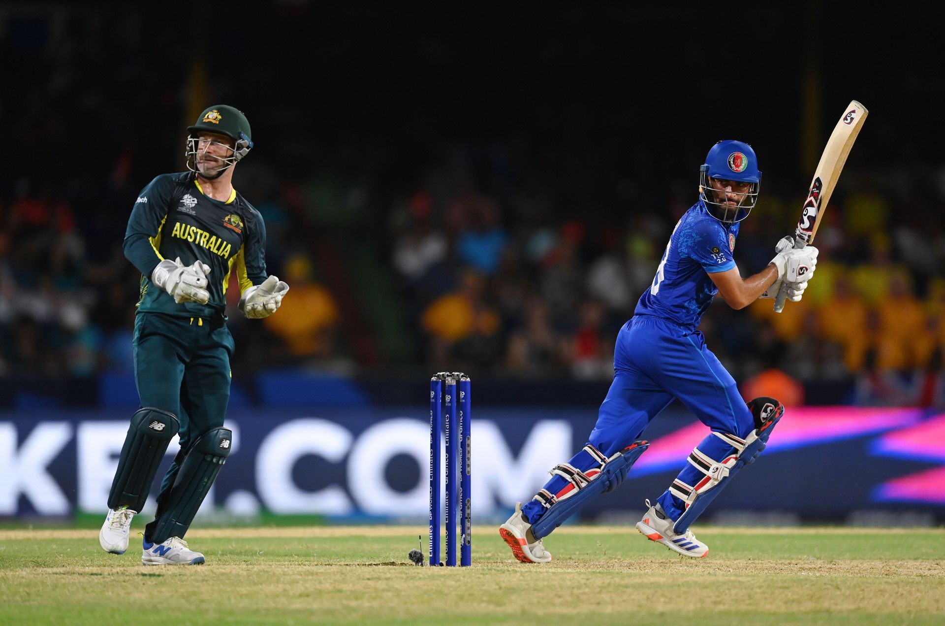 .brahim Zadran of Afghanistan bats as Matthew Wade of Australia looks on during the ICC Men's T20 Cricket World Cup West Indies & USA 2024 Super Eight match between Afghanistan and Australia at Arnos Vale Ground on June 22, 2024 in St Vincent, Saint Vincent and The Grenadines. (Photo by Gareth Copley/Getty Images).