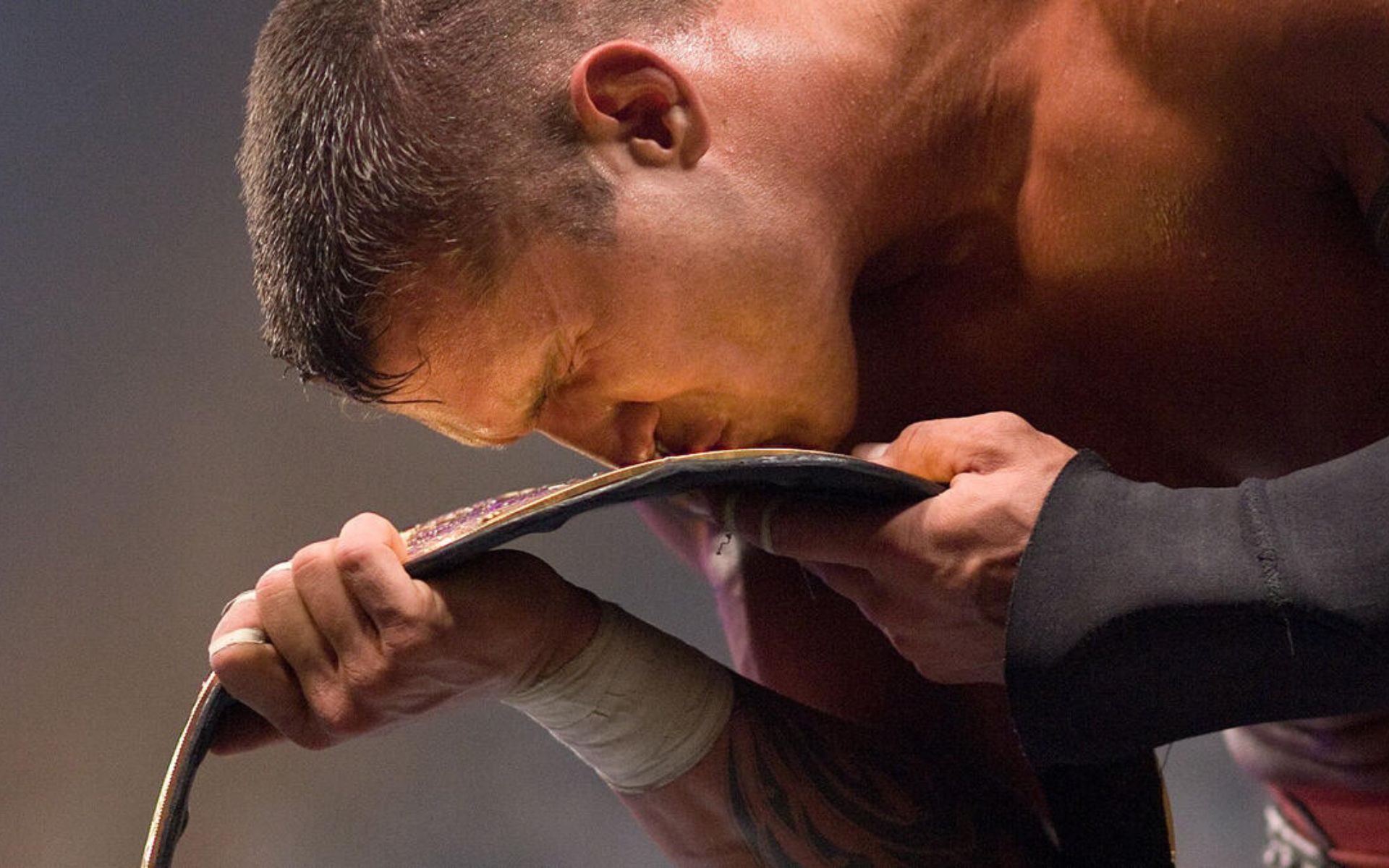 Orton kissing &quot;Big Gold&quot; World Heavyweight Championship. [Photo credit: WWE.com]