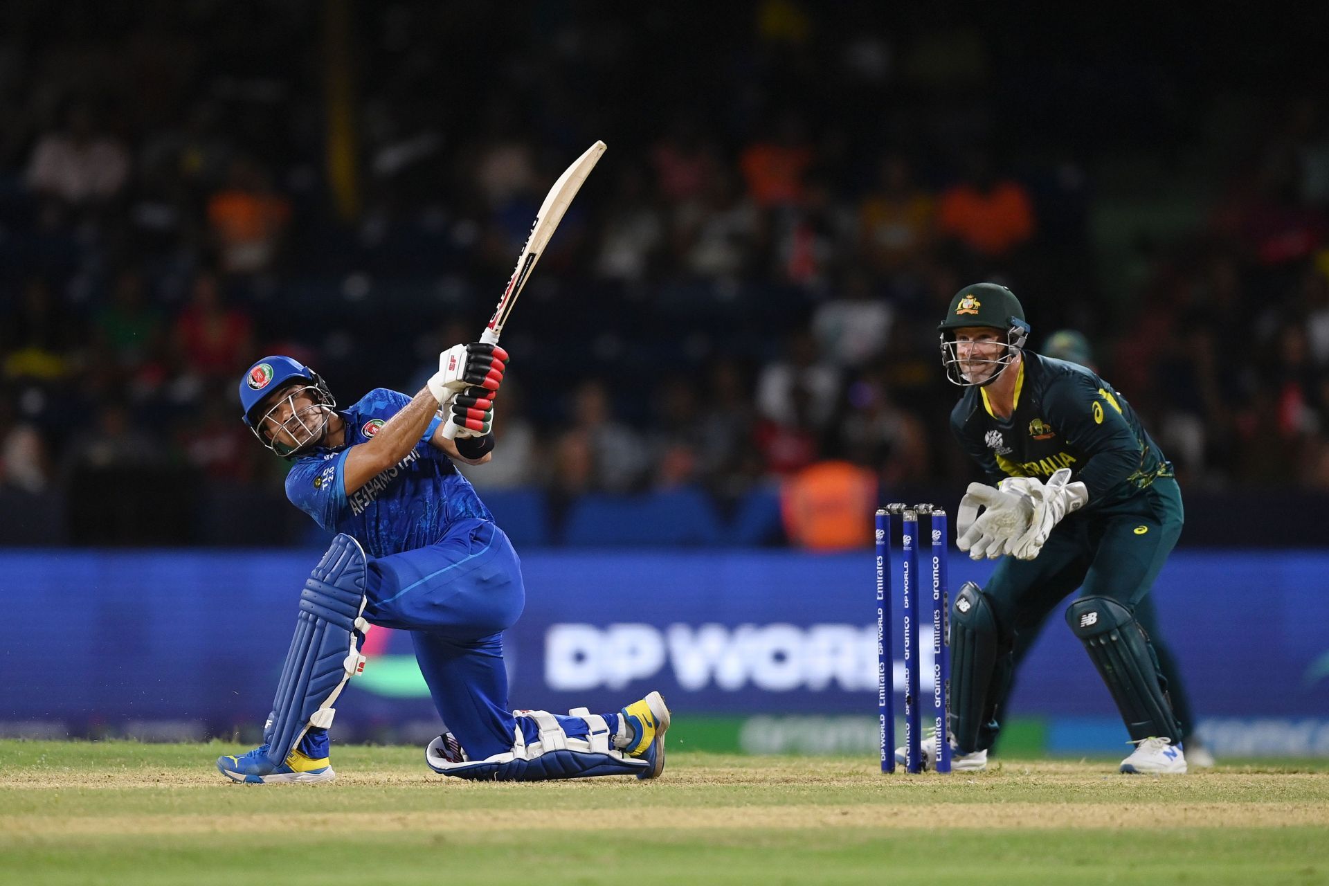 Rahmanullah Gurbaz of Afghanistan hits a six as Matthew Wade of Australia looks on during the ICC Men&#039;s T20 Cricket World Cup West Indies &amp; USA 2024 Super Eight match between Afghanistan and Australia at Arnos Vale Ground on June 22, 2024 in St Vincent, Saint Vincent and The Grenadines. (Photo by Gareth Copley/Getty Images).