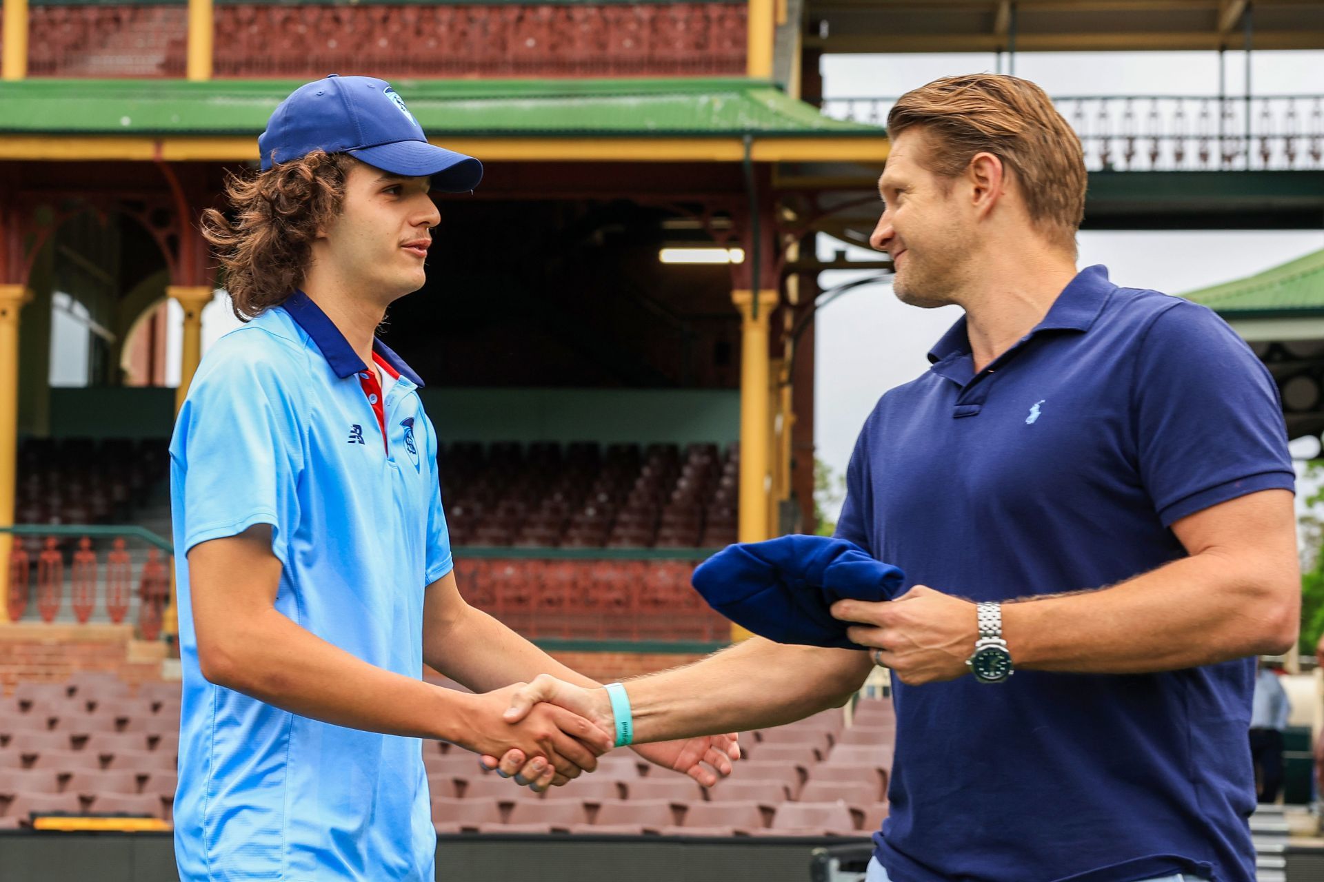 Sam Konstas of the Blues (L) receives his debut cap from Shane Watson ahead of his debut during the Sheffield Shield match between New South Wales and Tasmania at SCG, on November 28, 2023, in Sydney.