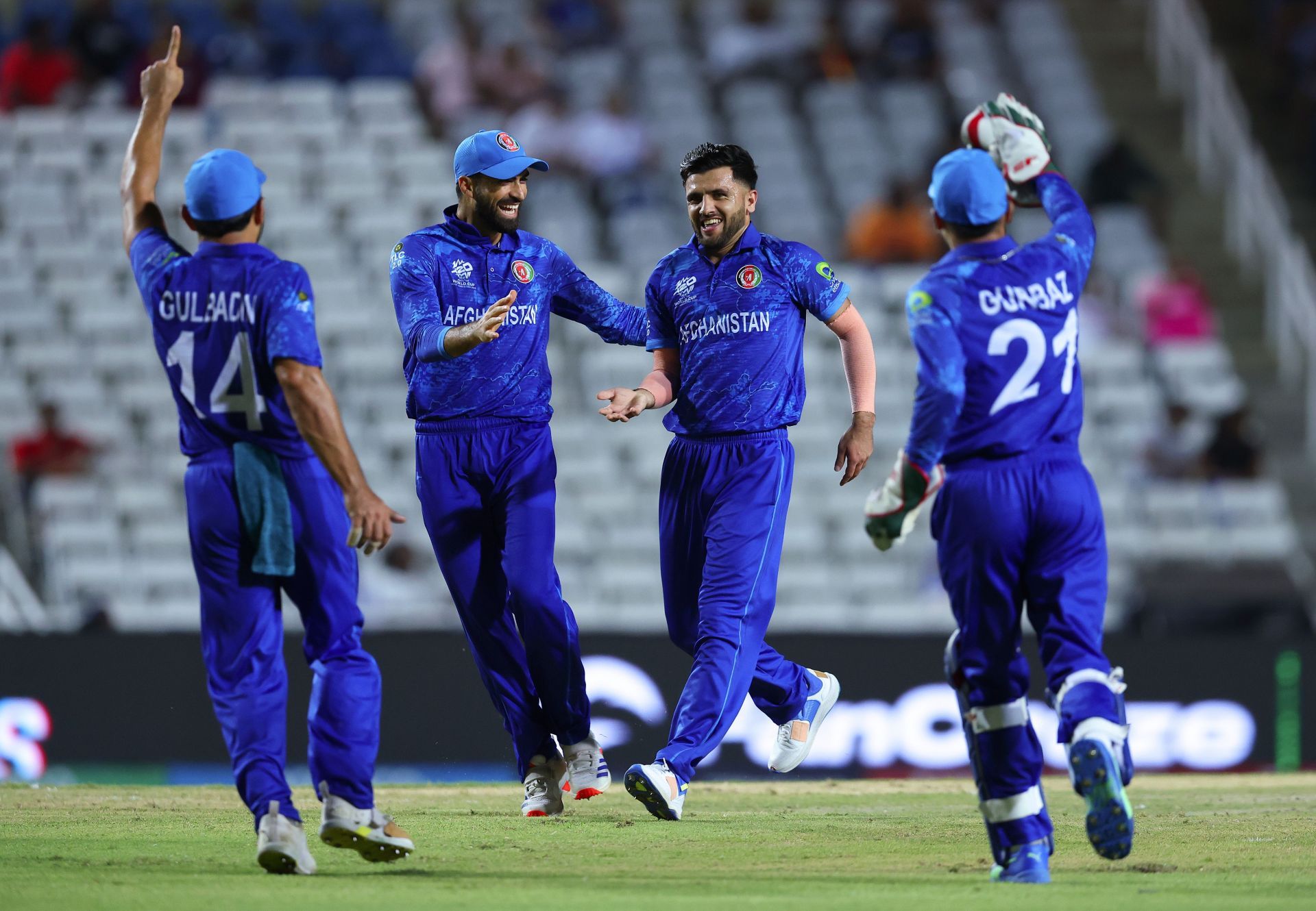 .Fazalhaq Farooqi of Afghanistan celebrates with teammates after dismissing Sese Bau of Papua New Guinea during the T20 Cricket World Cup. (Photo by Ashley Allen/Getty Images)