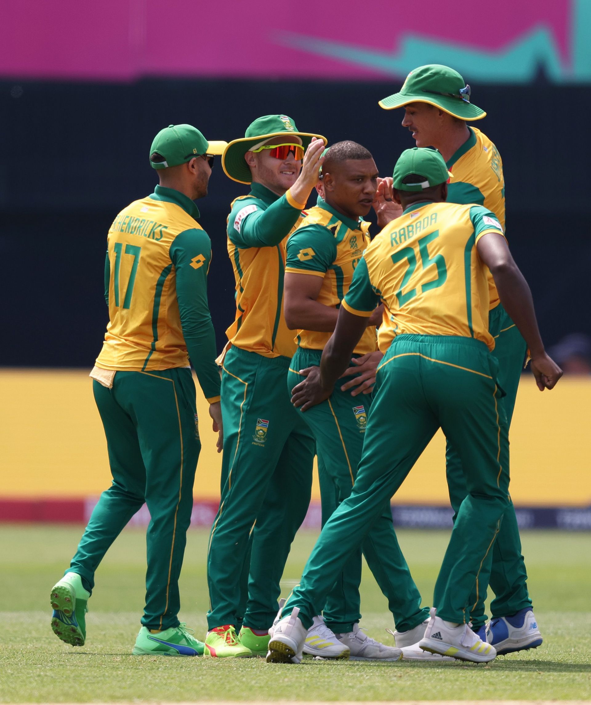 South African fielders celebrating with Ottniel Baartman in the middle.