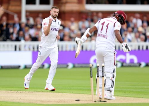 Gus Atkinson celebrates picking his maiden Test wicket at the Lord's.