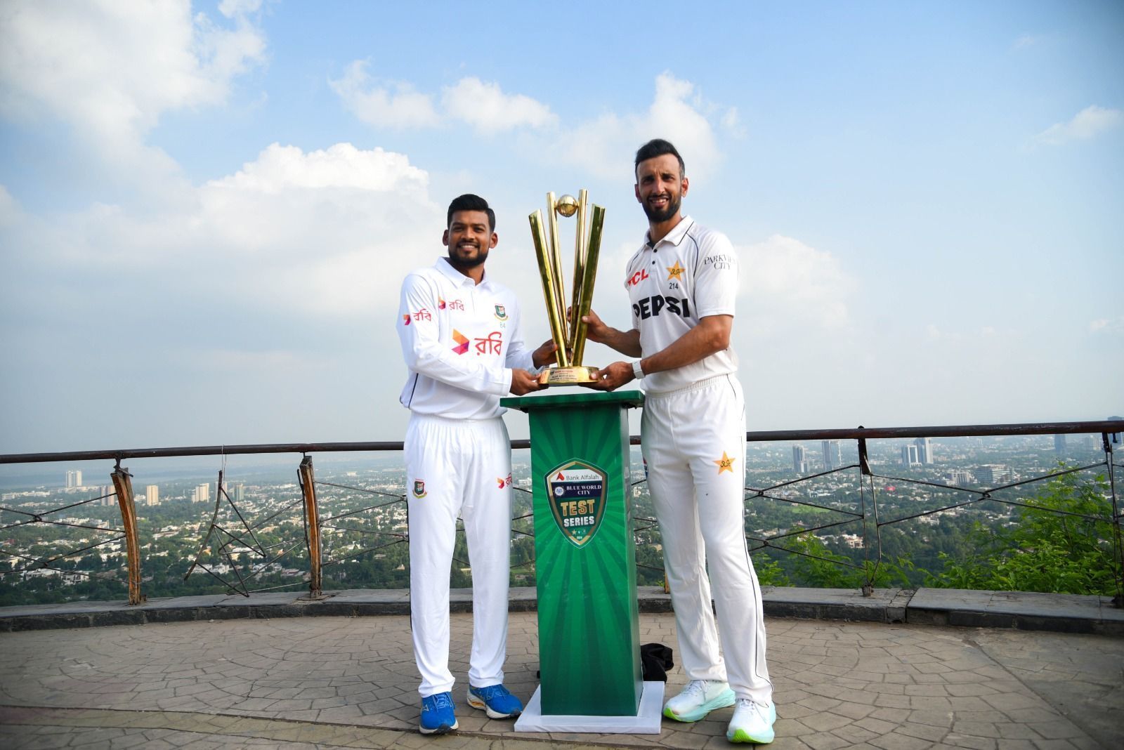 Bangladesh captain Najmul Hossain Shanto and Pakistan captain Shan Masood pose with the trophy they are about to fight for. [@TheRealPCB on X]