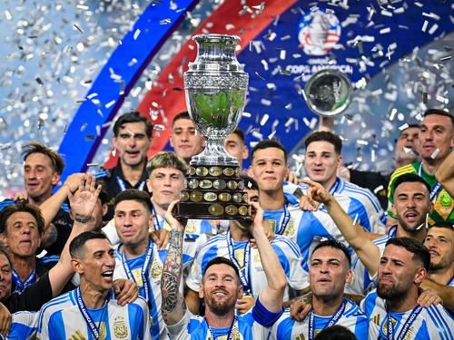 Lionel Messi hoists aloft the 2024 Copa America trophy.