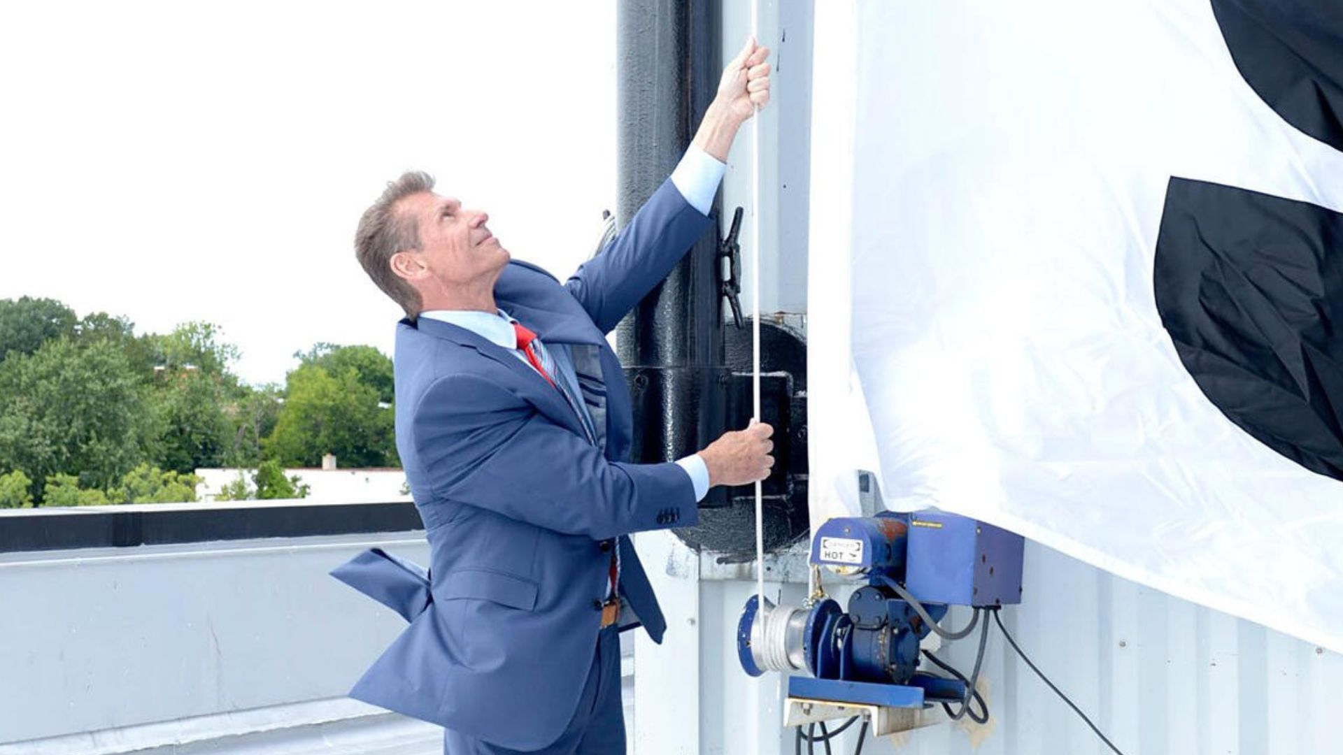 A photo of Vince McMahon unveiling the WWE logo [Image via wwe.com]