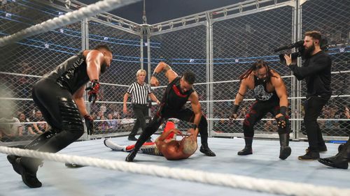 While near the action during the assault, the cameraman isn't counted among the Bloodline. {Image Credit: WWE.com}