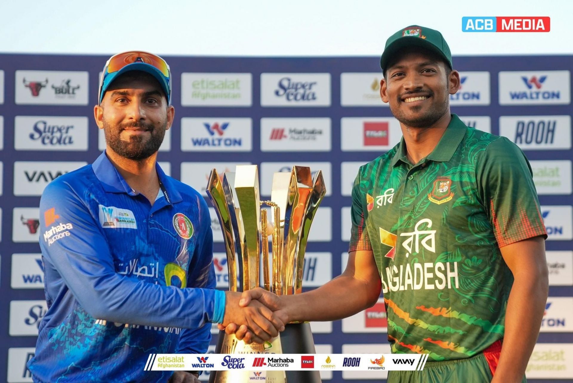 Hashmatullah Shahidi and Najmul Hossain Shanto with the ODI trophy 