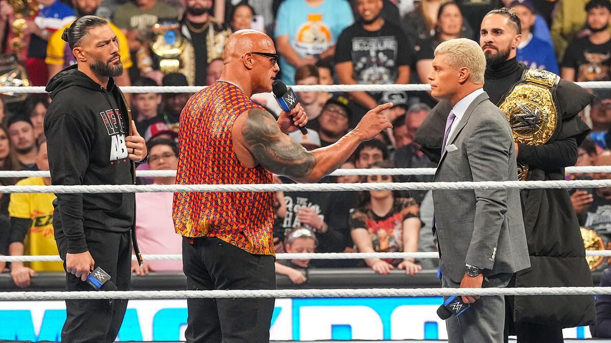 Roman Reigns, The Rock, Cody Rhodes and Seth Rollins in a WWE ring. (Photo: WWE.com)