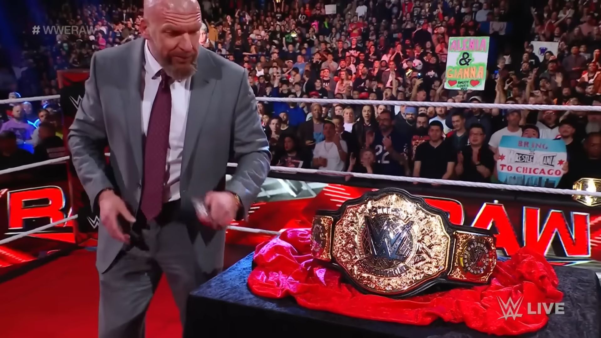 Triple H unveiling the world title (via WWE