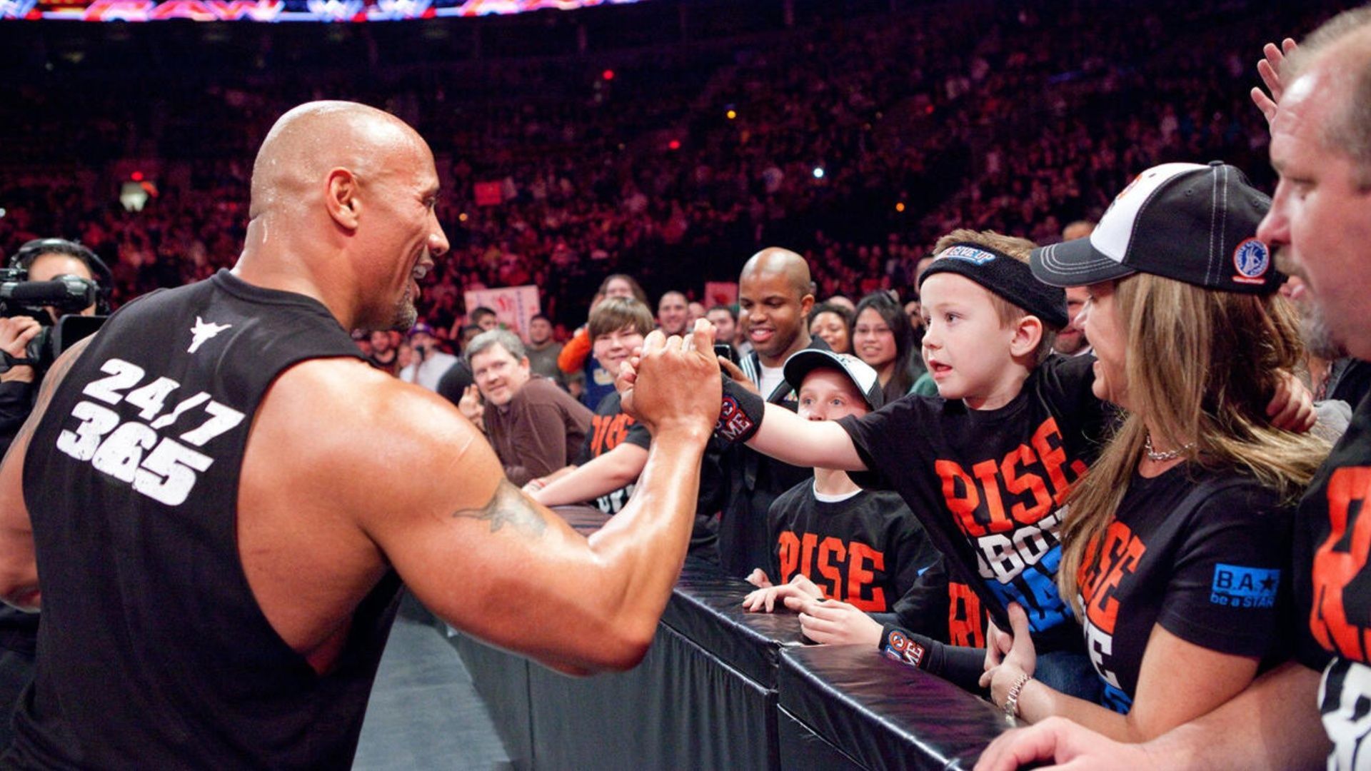 The Rock interacts with a young fan (Image via WWE.com)