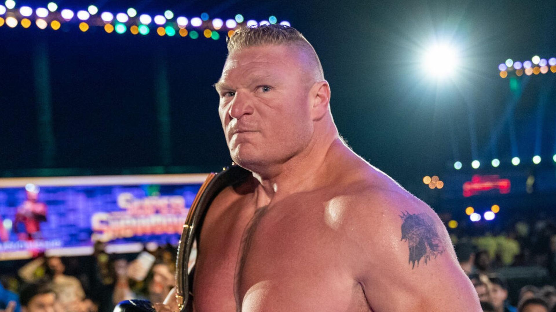 Brock Lesnar with the title! [Image credit: WWE.com]