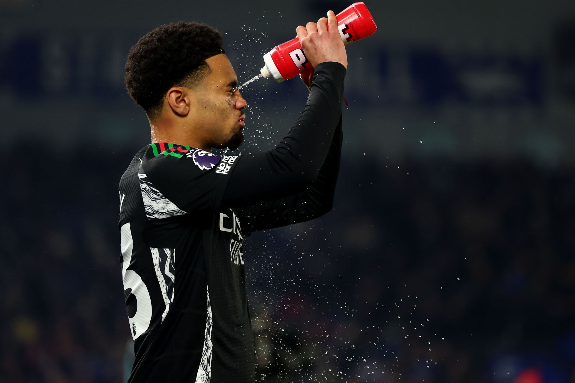 Nwaneri spraying water on his face during a break in the game. - Source: Getty