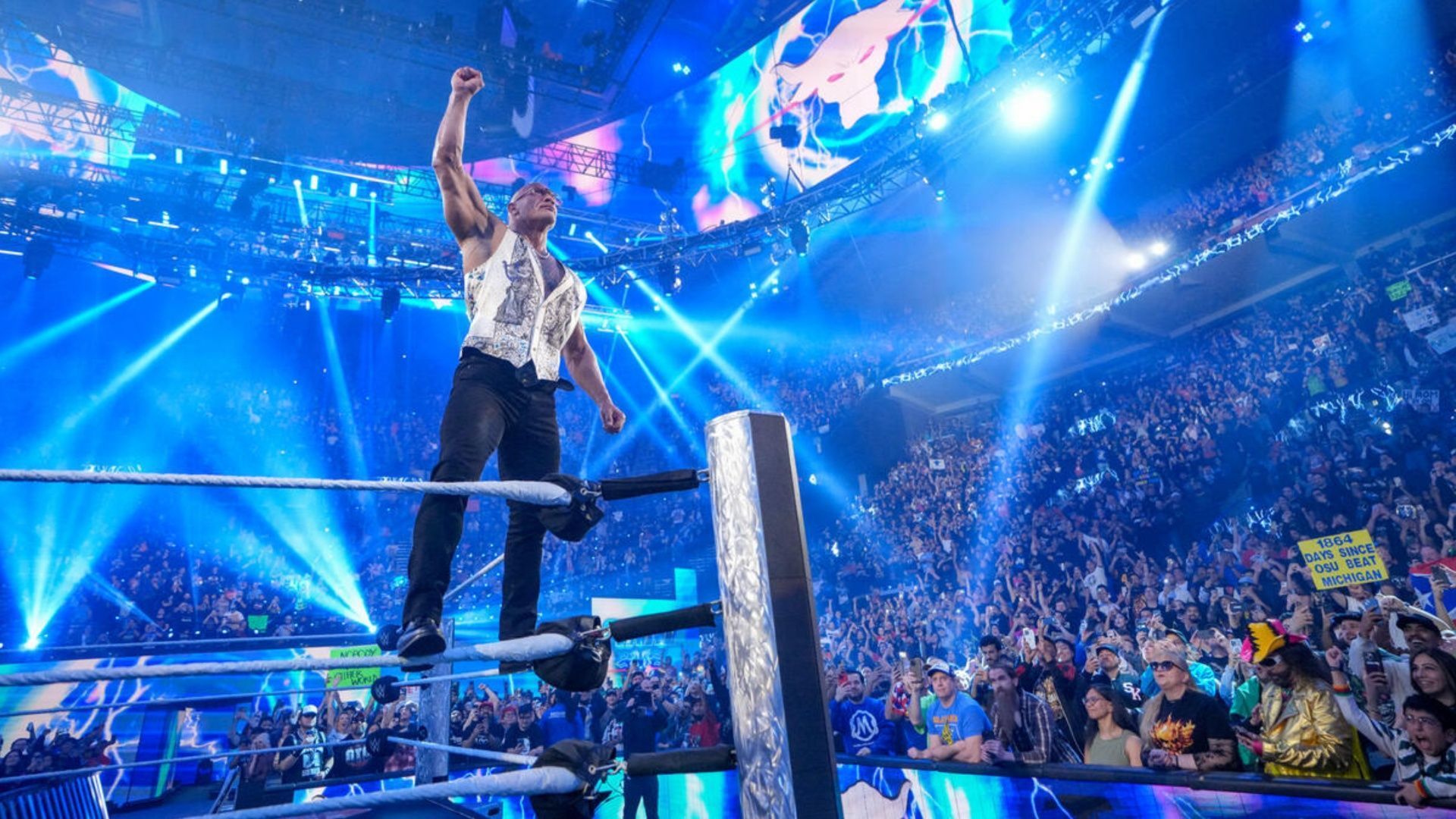 The Rock delivers his signature pose at a WWE event (Image via WWE.com)