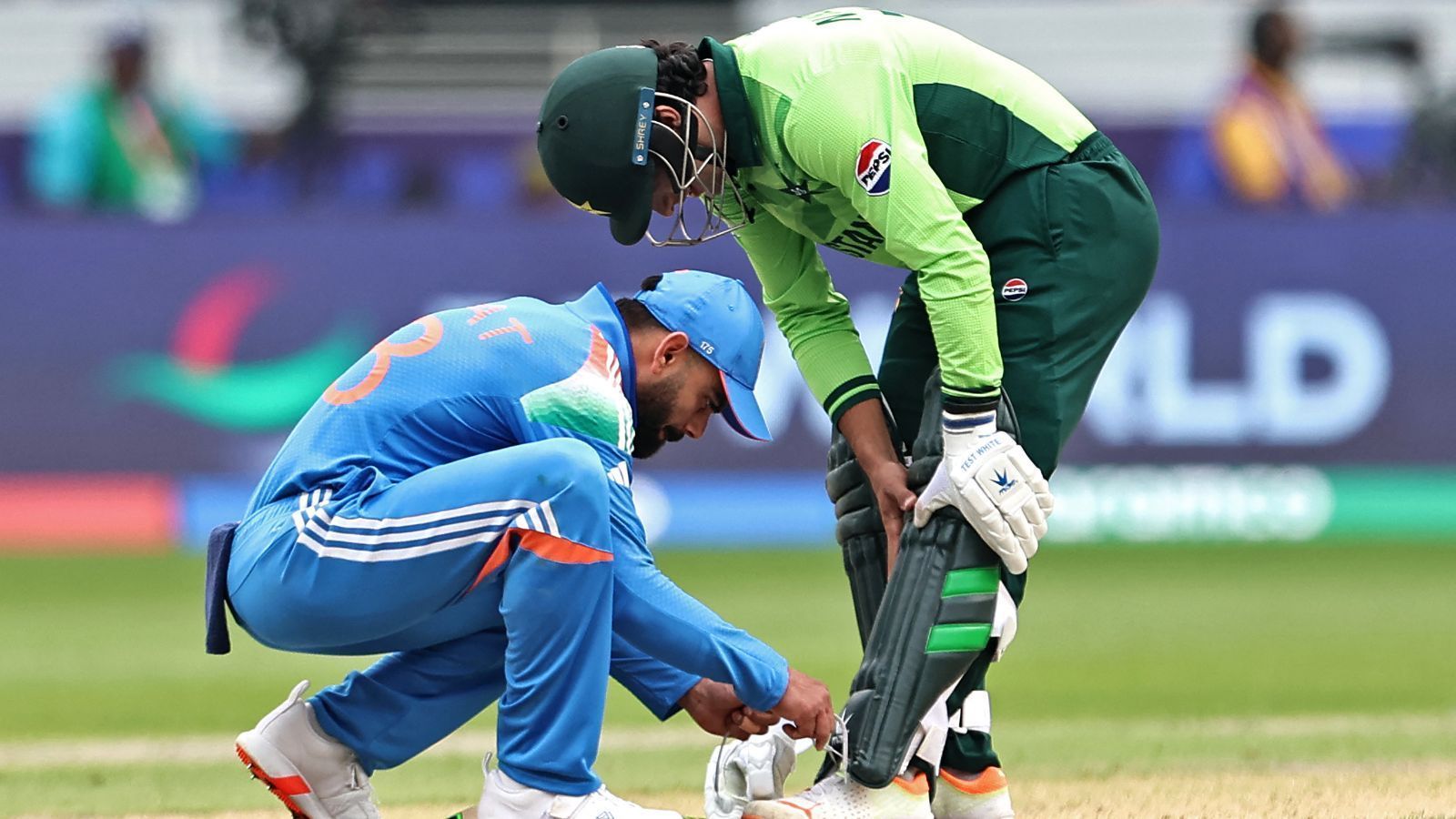 Virat Kohli assisting Naseem Shah with his shoe lace during CT match. (Image: ICC/X)