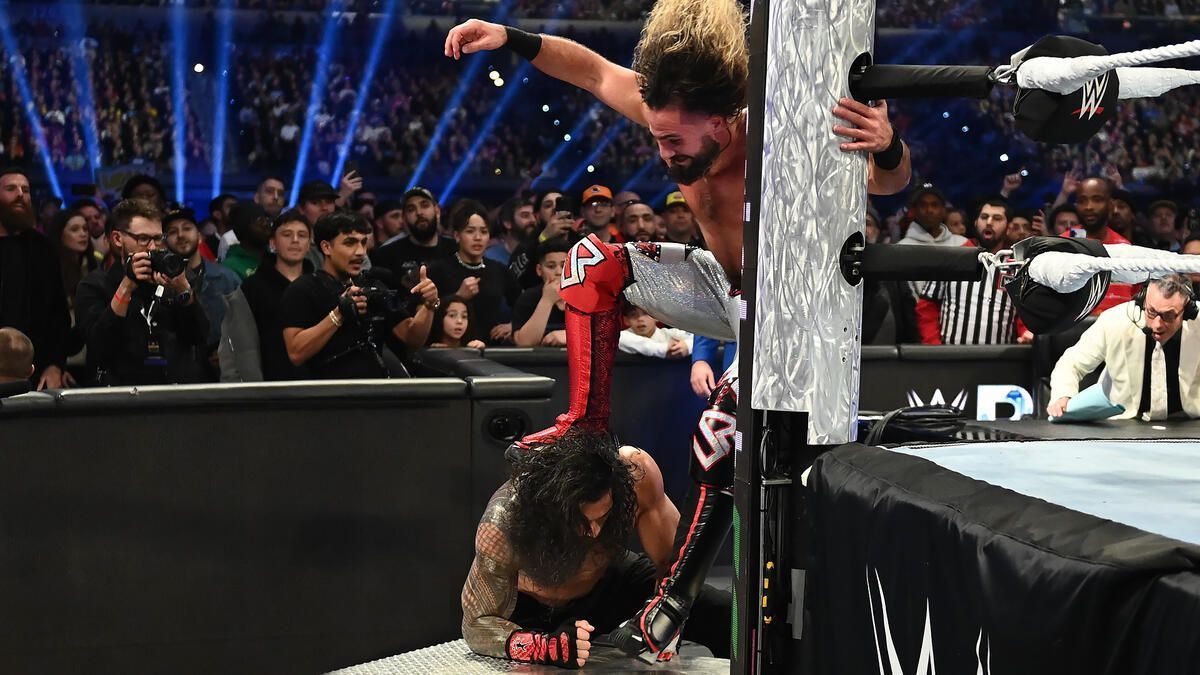 Seth Rollins hit a Curb Stomp on The Tribal Chief on the steel steps (Photo source: wwe.com)