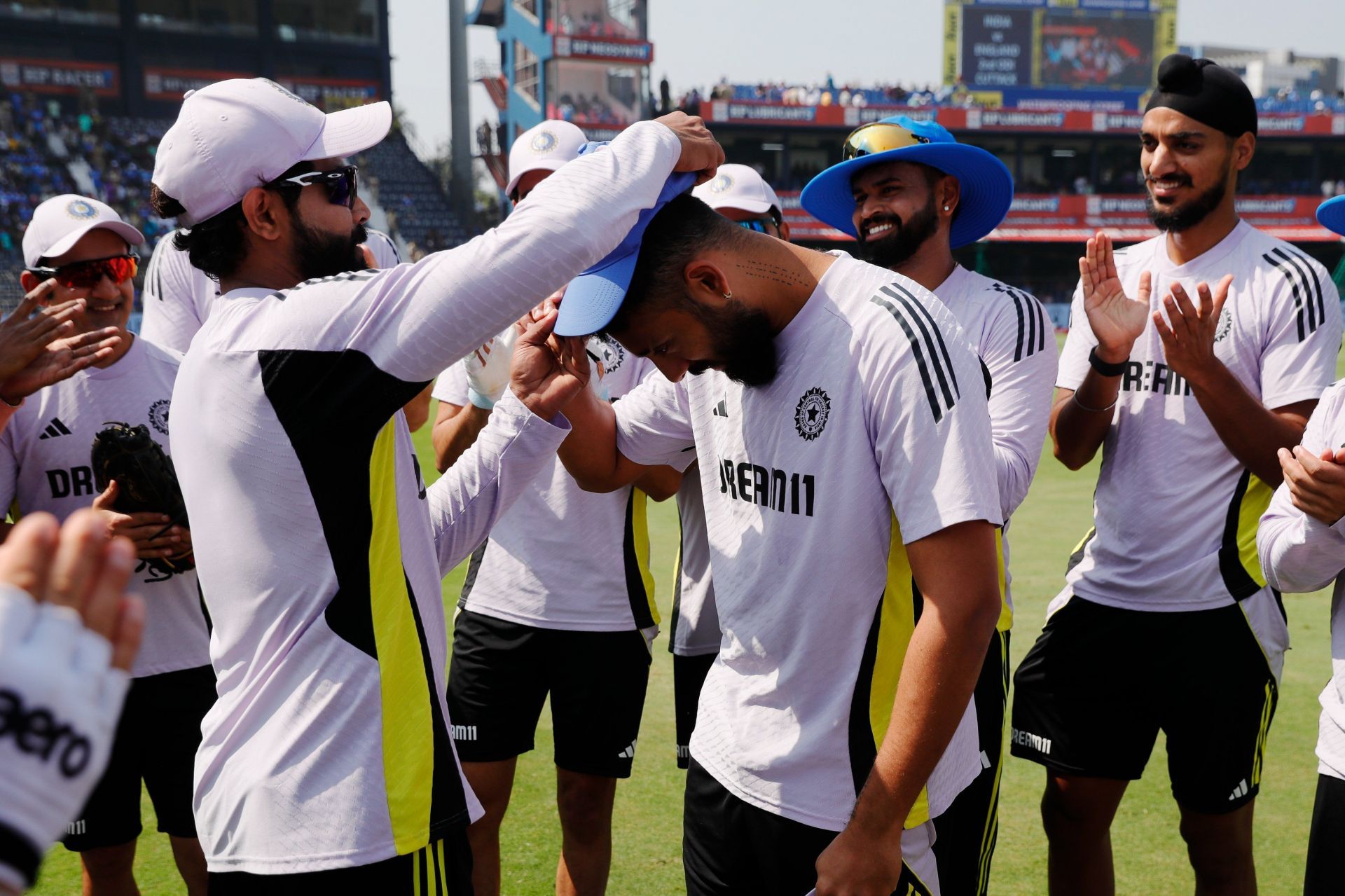 Varun Chakravarthy receiving his debut cap from Ravindra Jadeja. (Image: BCCI/X)