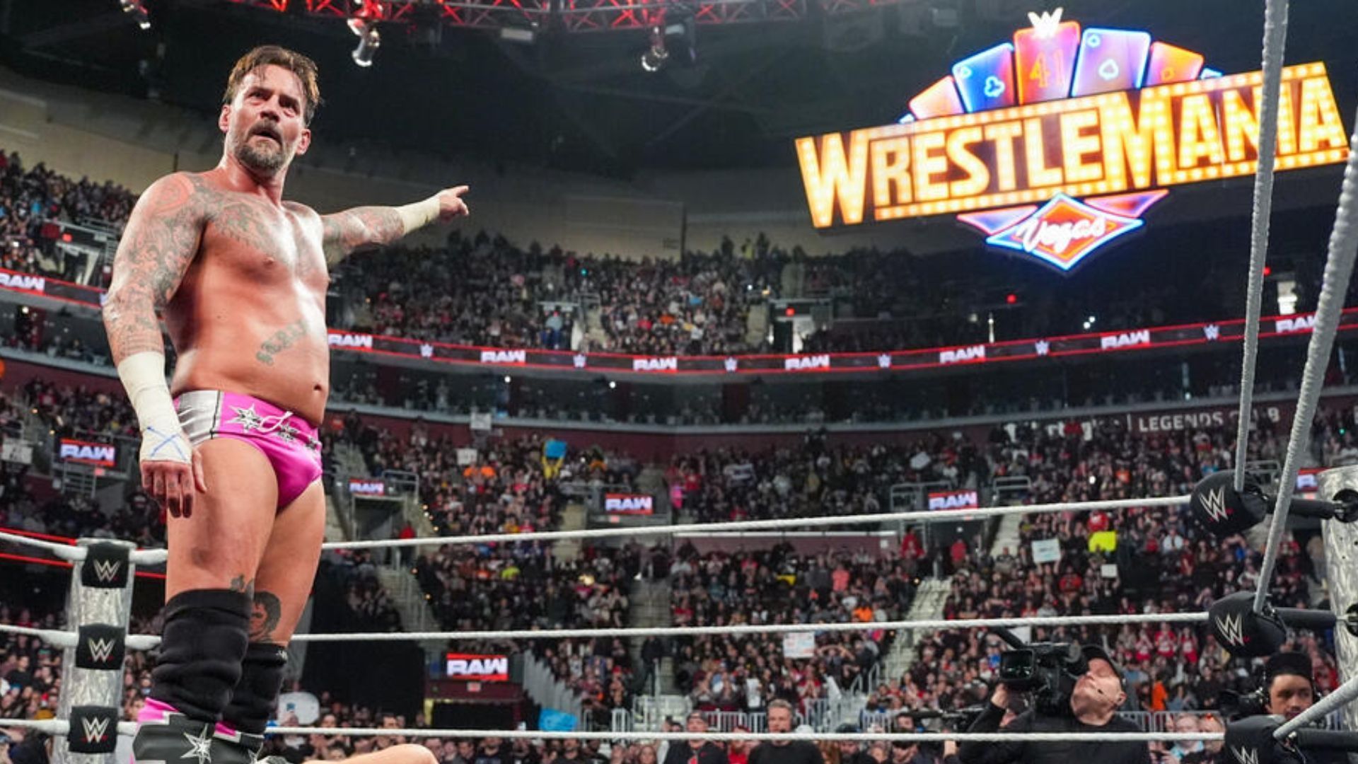 CM Punk pointing at the WrestleMania sign (Image via wwe.com)