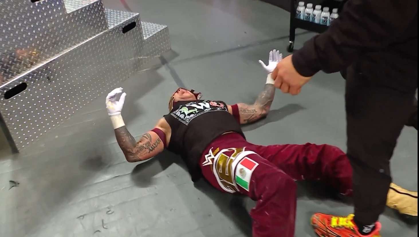 Rey Mysterio was taken out by a crazed masked assailant! (Credit: WWE on X)