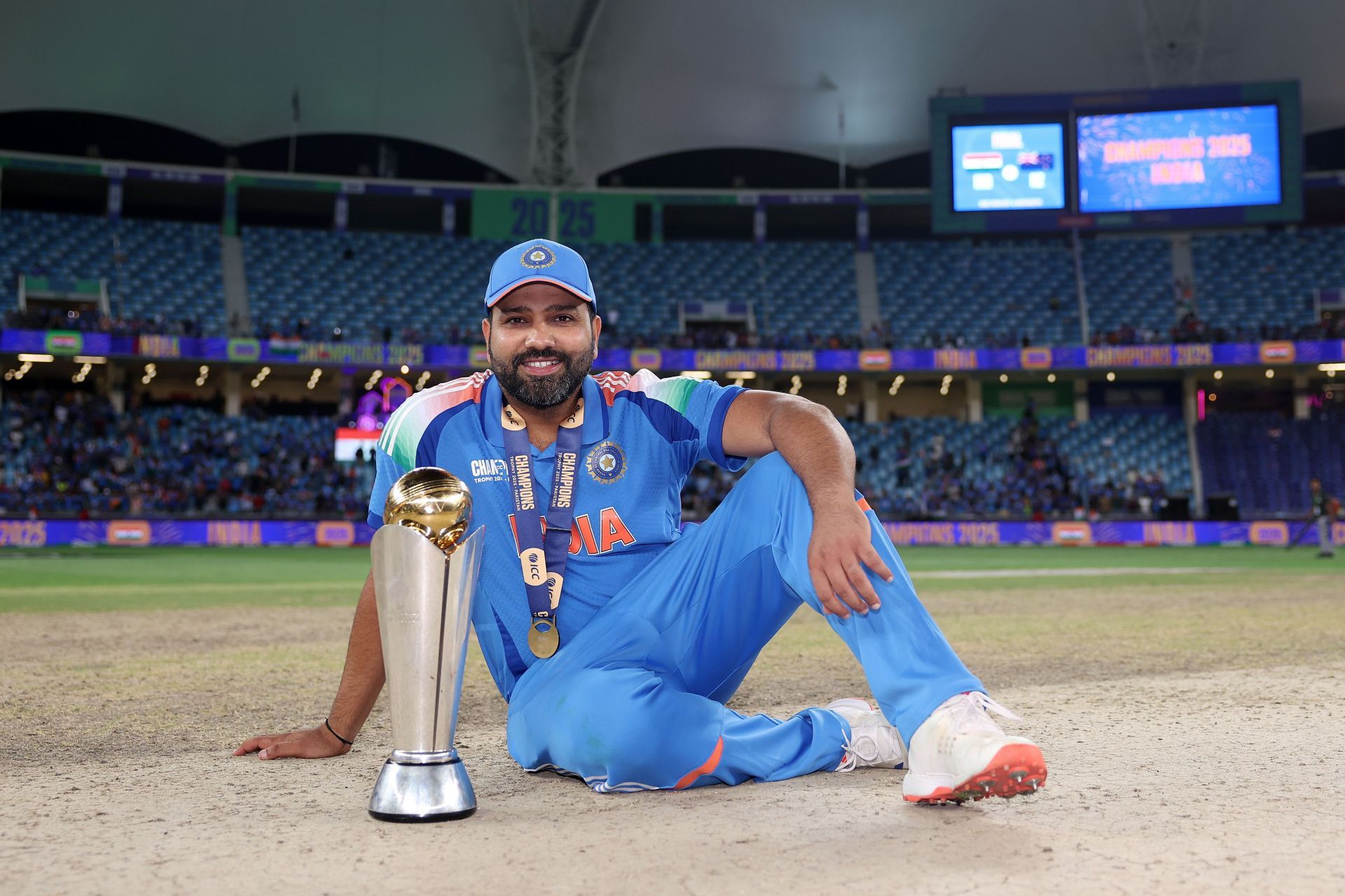 The Indian captain poses with the Champions Trophy. Source: Getty