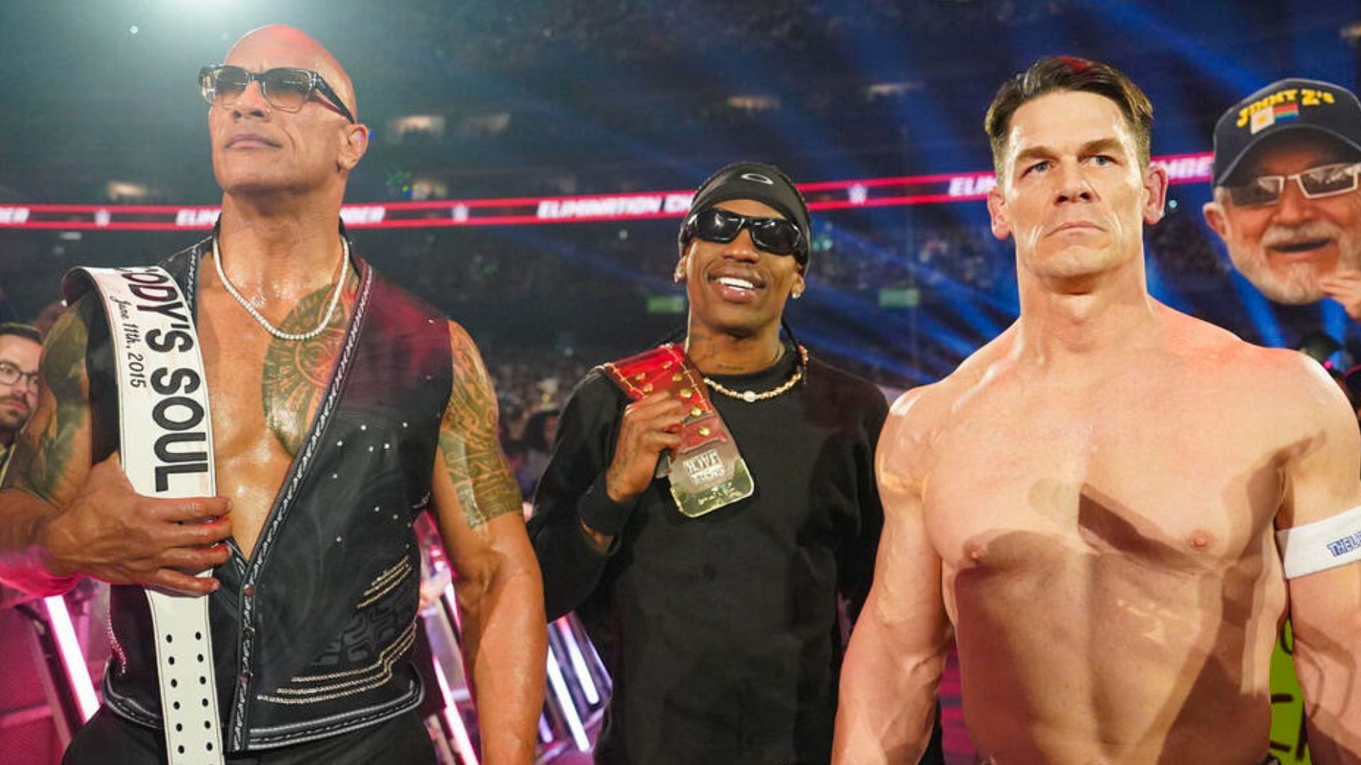 The Rock, Travis Scott, and John Cena (left to right) at Elimination Chamber. [Image from WWE.com]