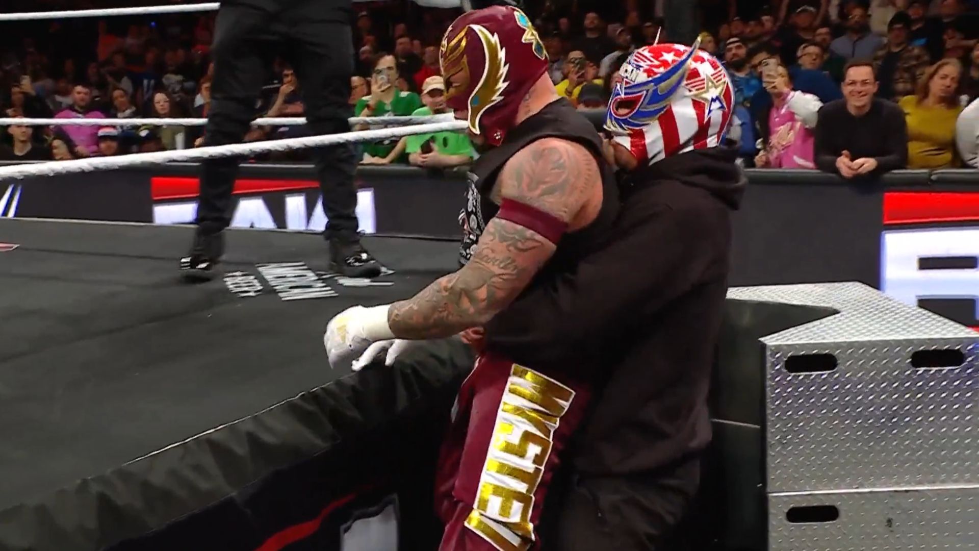 Rey Mysterio and the mystery attacker [Image Credits: WWE