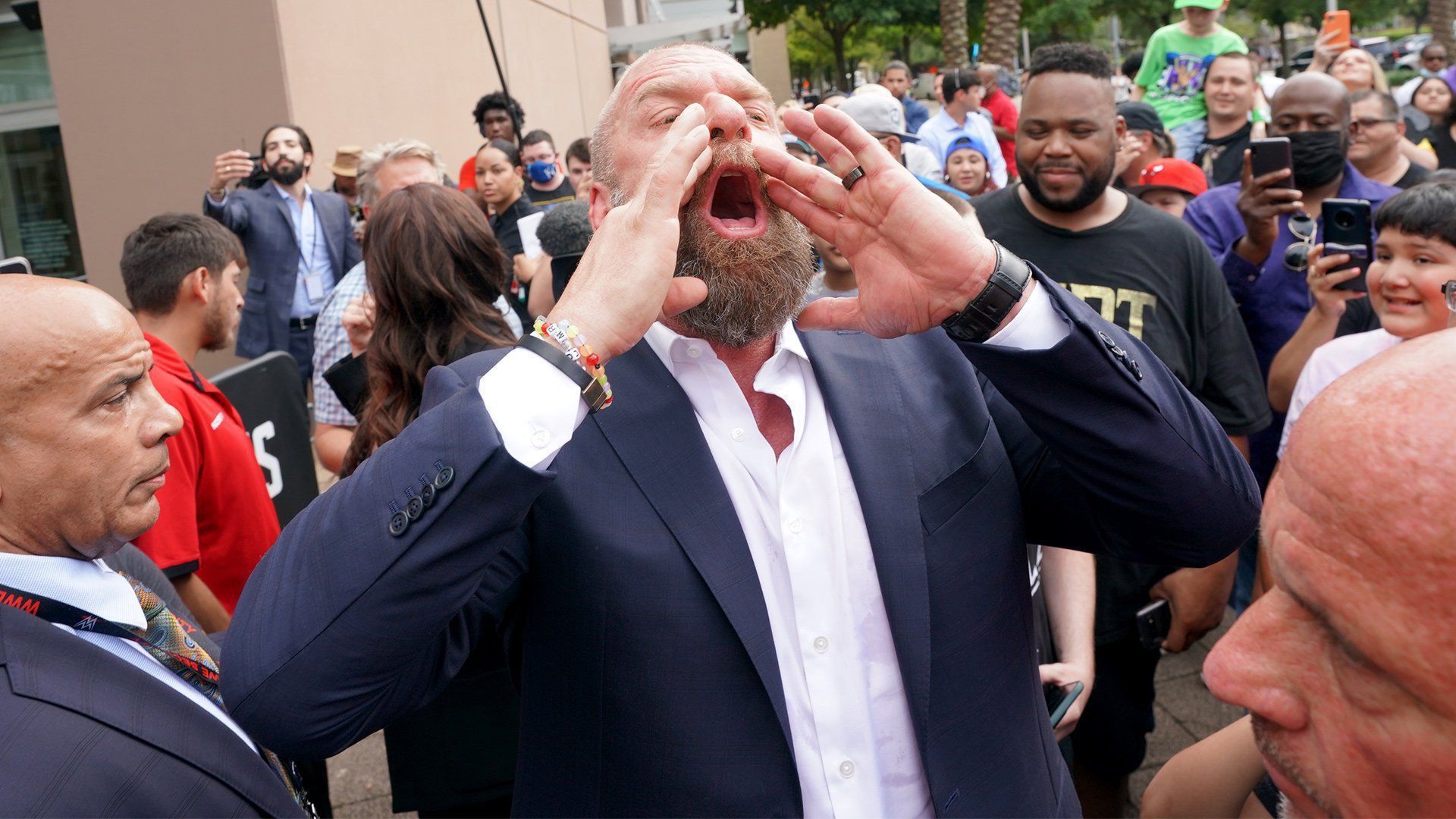 WWE CCO Triple H shouts an announcement to the WWE Universe