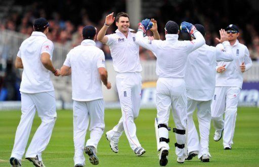 England&#039;s James Anderson (3rd L) celebrates taking the wicket of West Indies batsman Kieran Powell