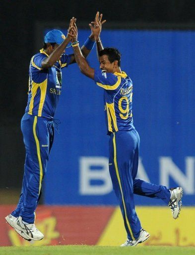 Sri Lankan cricketer Nuwan Kulasekera (R) celebrates with his teammate Angelo Mathews