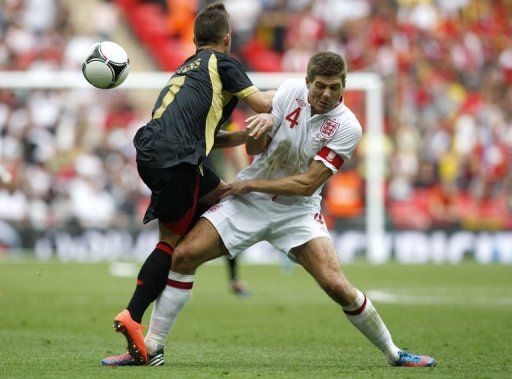 Belgium&#039;s Dries Mertens (L) collides with England&#039;s Steven Gerrard