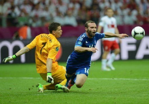 Greek forward Dimitris Salpingidis (R) is fouled by Polish goalkeeper Wojciech Szczesny