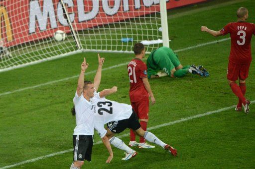 German forward Lukas Podolski (L) celebrates a goal by German forward Mario Gomez (C)