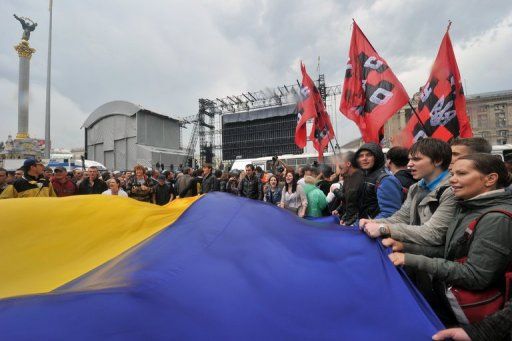 Protesters wave a Ukraine flag in Kiev on June 5 against a bill increasing use of the Russian language in the country