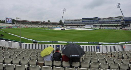 Fans wait for the rain to pass at Edgbaston on Monday