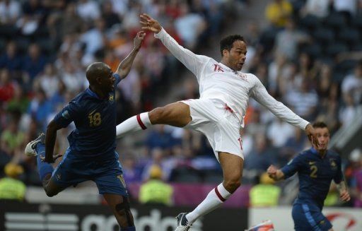 English defender Joleon Lescott (right) rises above French midfielder Alou Diarra to score