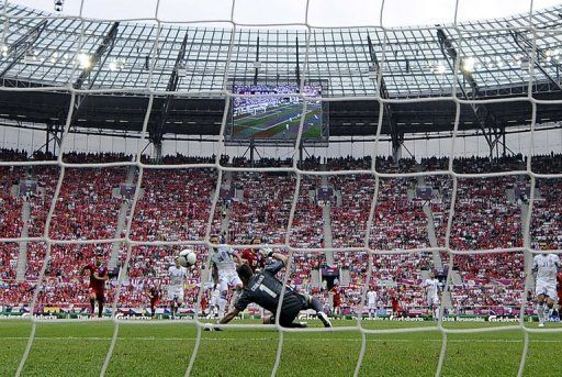 Czech midfielder Petr Jiracek (C back) scores in the nets of Greek goalkeeper Kostas Chalkias