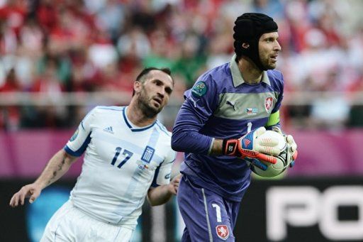 Czech goalkeeper Petr Cech (R) catches the ball next to Greek forward Fanis Gekas