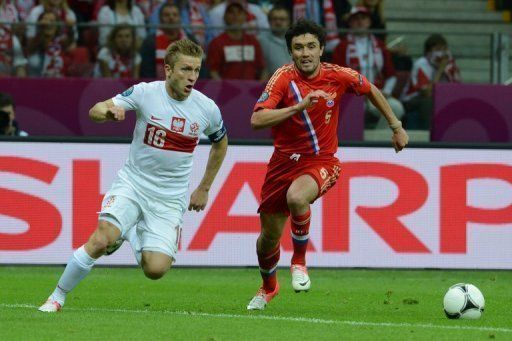 Polish captain &#039;Kuba&#039; Blaszczykowski (left) scored in the 57th minute to earn the Poles a deserved point