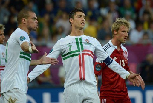 Portuguese forward Cristiano Ronaldo (C) and defender Pepe argue with the referee