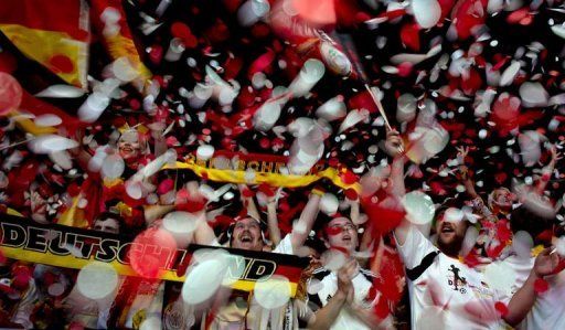 German fans celebrate their team&#039;s win over Holland near the Brandenburg Gate in Berlin