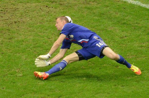 Russian goalkeeper Vyacheslav Malafeev fails to stop a goal