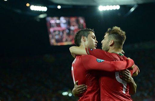 Portuguese forward Cristiano Ronaldo (R) celebrates with Portuguese midfielder Miguel Veloso after scoring