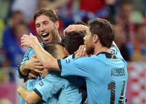 Spanish defender Sergio Ramos (L) reacts as he celebrates with teammates