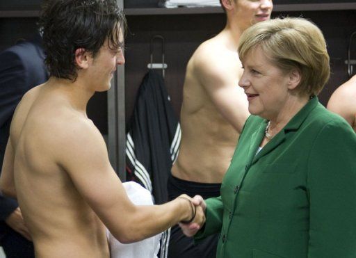 Merkel congratulates Germany&#039;s Mesut Ozil after a Euro 2012 qualifier in Berlin in 2010