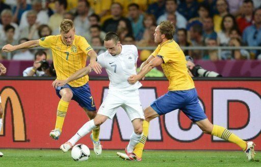 France&#039;s Franck Ribery (centre) is tackled by two Swedish players during a group match in Kiev