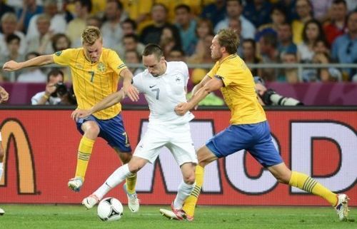 France's Franck Ribery (centre) is tackled by two Swedish players during a group match in Kiev