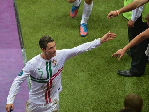 Cristiano Ronaldo cheers with fans as he leaves the pitch