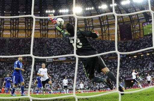 German defender Philipp Lahm (R) scores past Greek goalkeeper Michalis Sifakis (C)