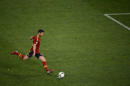Spanish midfielder Xabi Alonso kicks a penalty